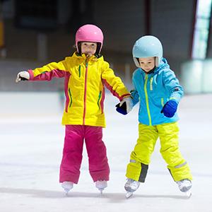 Two children learning to skate